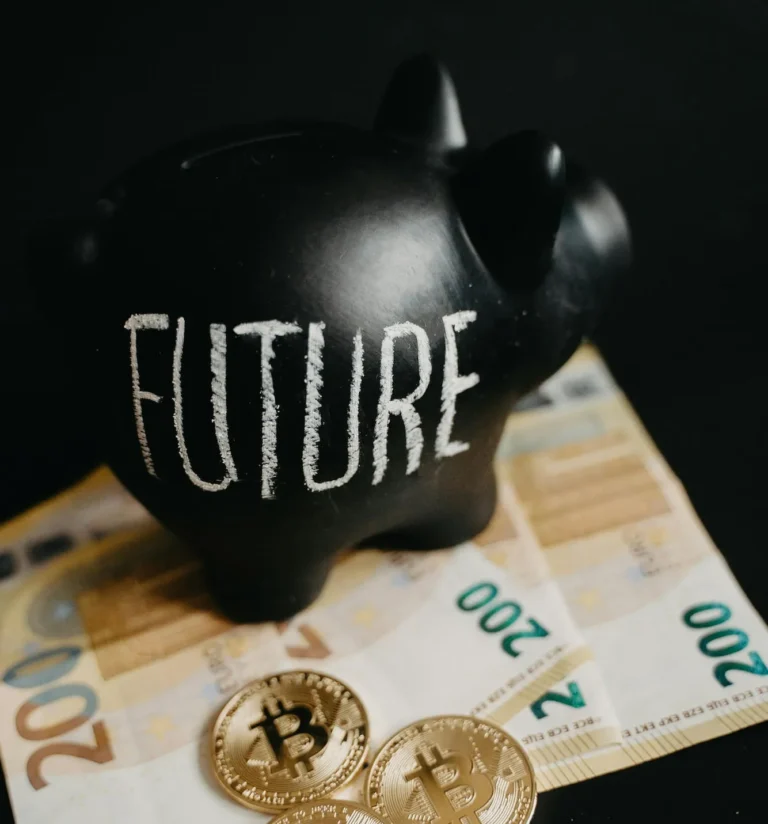 A black piggy bank labeled “FUTURE” sits atop of banknotes with Bitcoin coins in front, symbolizing Cryptocurrency Business Advancement through data assets, crypto innovation, and DeFi strategies in modern finance.