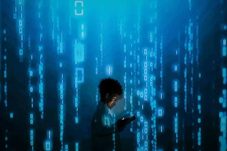 A person stands surrounded by streams of binary code, holding a glowing tablet, symbolizing disaster recovery in the digital age through data resilience, cybersecurity, and tech-driven continuity.