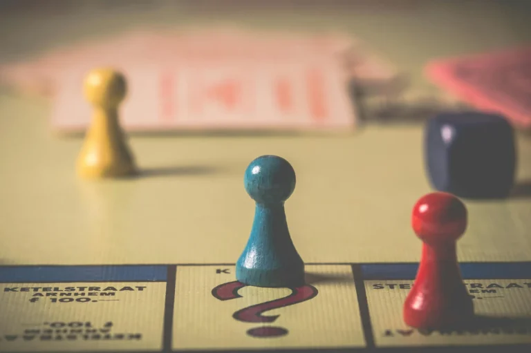 Monopoly game pieces and a die rest on a board’s “Chance” space, symbolizing Fintech Brand Growth Tactics—strategic moves that build market authority through calculated risks and competitive positioning.