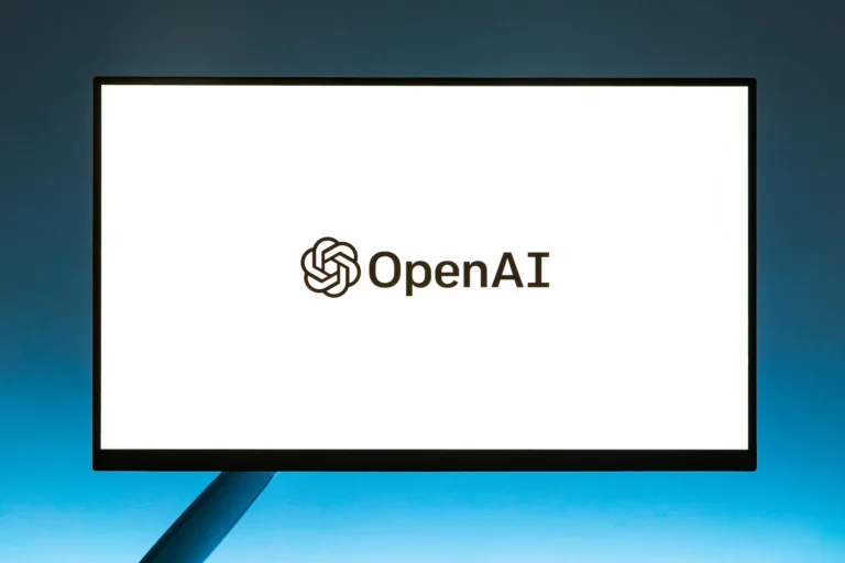 A computer monitor displays the OpenAI logo against a sleek blue gradient background, symbolizing OpenAI Tech Innovations in chips, GPT models, and enterprise AI reshaping digital intelligence and business solutions.