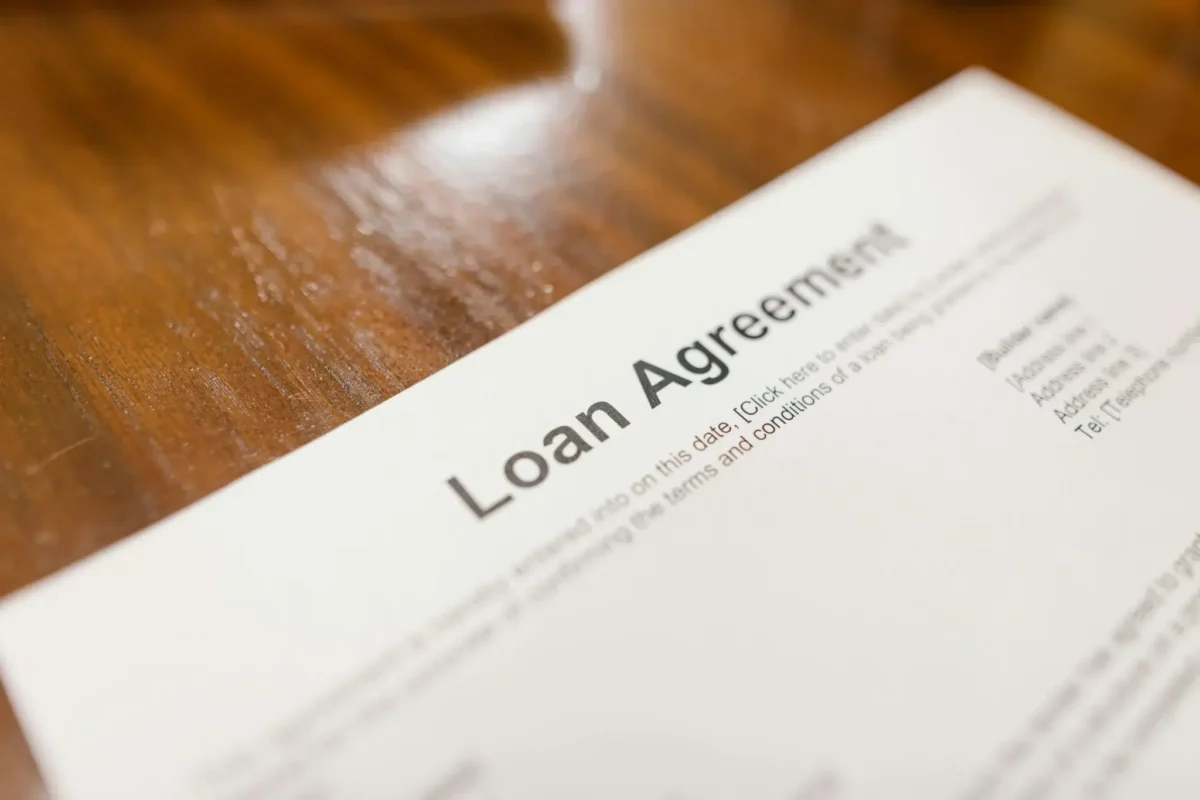 A printed “Loan Agreement” document rests on a wooden surface, symbolizing SBA Loans for Marketing Growth, funding strategies that empower small businesses to invest in visibility, outreach, and scalable campaigns.