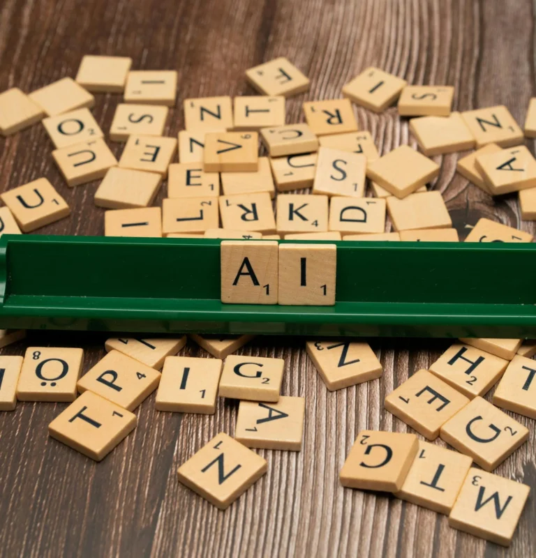 Scrabble tiles forming the word AI symbolize innovation in FinTech news and the growing role of artificial intelligence in business.