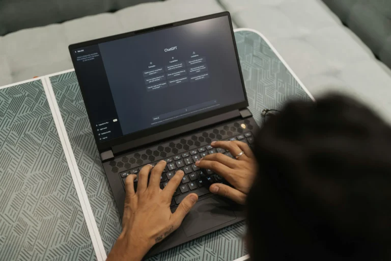 A person types on a laptop displaying the ChatGPT interface with sections for “Examples,” “Capabilities,” and “Limitations”, symbolizing AI Search Engine Updates Redefining Digital Strategies through conversational interfaces, intelligent query handling, and adaptive content generation that reshape how users engage with search, marketing, and digital planning.