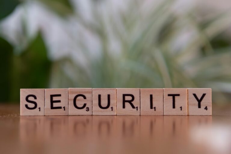 Scrabble-style tiles spell out the word "SECURITY" on a reflective surface with a blurred green background, symbolizing Cybersecurity Marketing Strategies for Market Authority through creative messaging, brand positioning, and visual storytelling that reinforce trust, protection, and leadership in digital security markets.