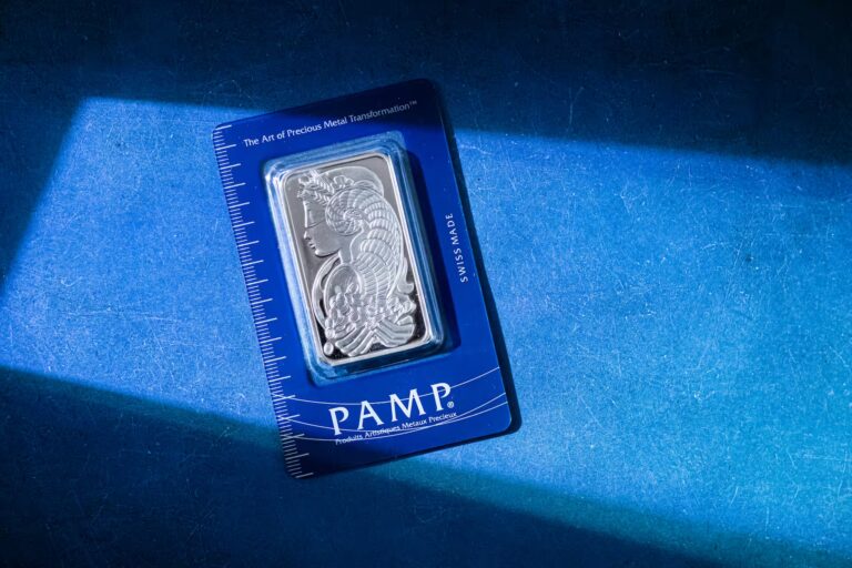 A PAMP Swiss silver bar in blue packaging featuring an artistic profile design rests on a dark surface with a ruler scale, symbolizing Silver Price Growth Driving Global Investment Strategies through premium bullion branding, rising demand for precious metals, and the strategic role of silver in diversified portfolios and inflation-hedging tactics.