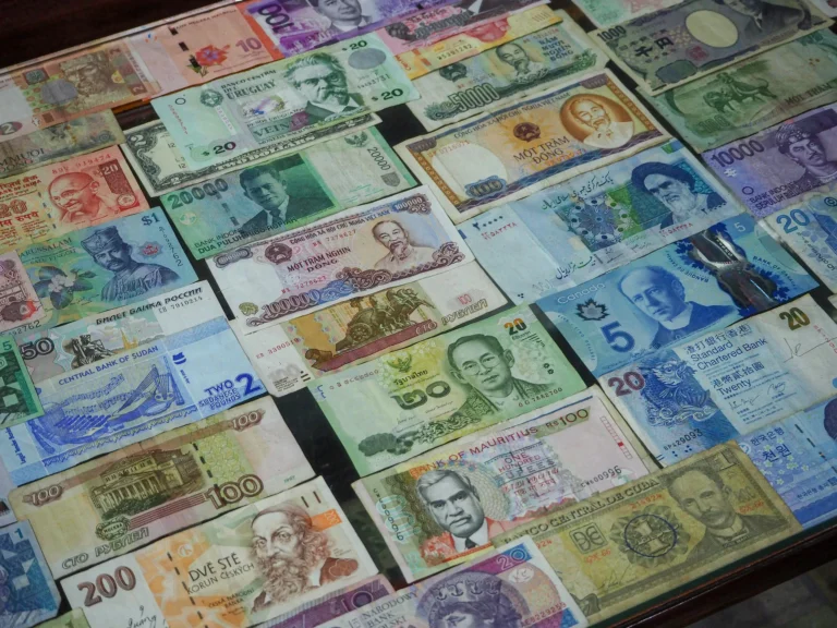 A diverse array of international banknotes from multiple countries displayed on a flat surface, symbolizing Stock Market Global Investing Strengthening Entrepreneurial Edge through cross-border financial awareness, currency diversification, and global market access that empowers entrepreneurs to build resilient, opportunity-driven investment strategies.
