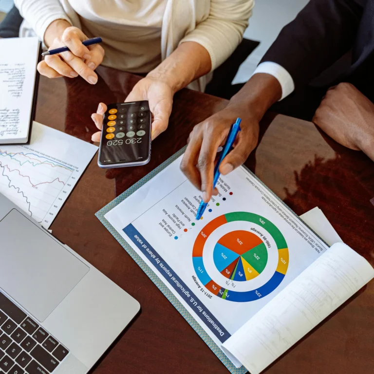 Two individuals collaborate over a smartphone calculator displaying “230,520” and a printed chart titled “Distributions of U.S. Equities by Shares of Value”, symbolizing SBA Loans for Tech Startups Scaling Innovation through data-driven financial planning, sector diversification, and strategic funding that empowers emerging tech ventures to grow with precision and market insight.