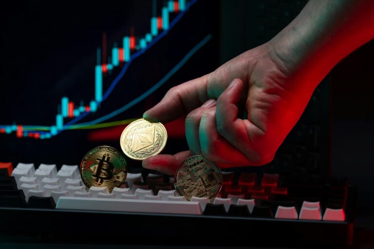 A hand holds a gold Ethereum coin above a mechanical keyboard, with Bitcoin and circuit-themed coins nearby and a computer screen displaying a colorful candlestick chart, symbolizing Bitcoin Investment Strategies for Digital Growth through cryptocurrency diversification, market trend analysis, and blockchain-based asset positioning that drive innovation, portfolio expansion, and digital financial evolution.