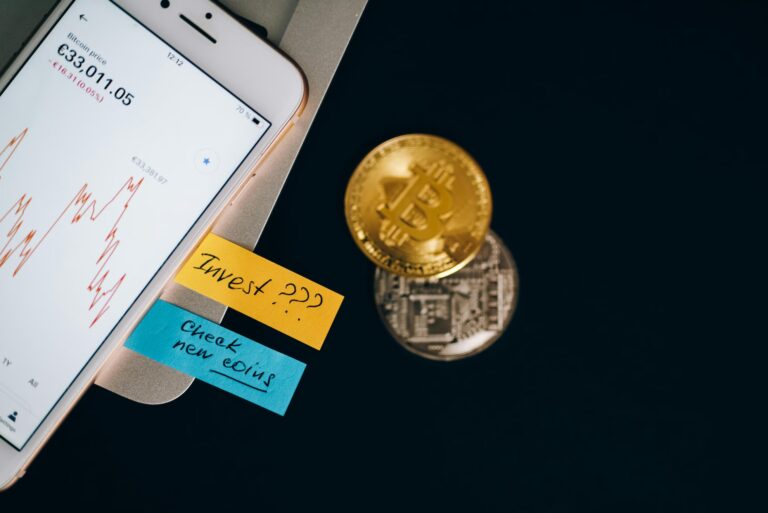 A smartphone displays a financial chart with a €30,011.05 value alongside sticky notes reading “Invest ???” and “Check new coins,” with physical Bitcoin and altcoin tokens nearby, symbolizing Global Bitcoin Price Updates for Investors through real-time mobile tracking, crypto market alerts, and founder-led investment strategies that empower traders to monitor global price shifts, evaluate new digital assets, and make informed decisions in fast-moving decentralized markets.