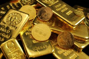 A collection of stamped gold bars and minted coins, including Krugerrands and Austrian bullion, arranged with visible purity marks and serial numbers, symbolizing Gold Price Growth Mastering the 2026 Institutional Breakout through physical asset accumulation, sovereign-grade investment strategy, and founder-led portfolio positioning that empower institutions to hedge volatility, scale reserve strength, and capitalize on macroeconomic shifts driving gold’s resurgence in global finance.