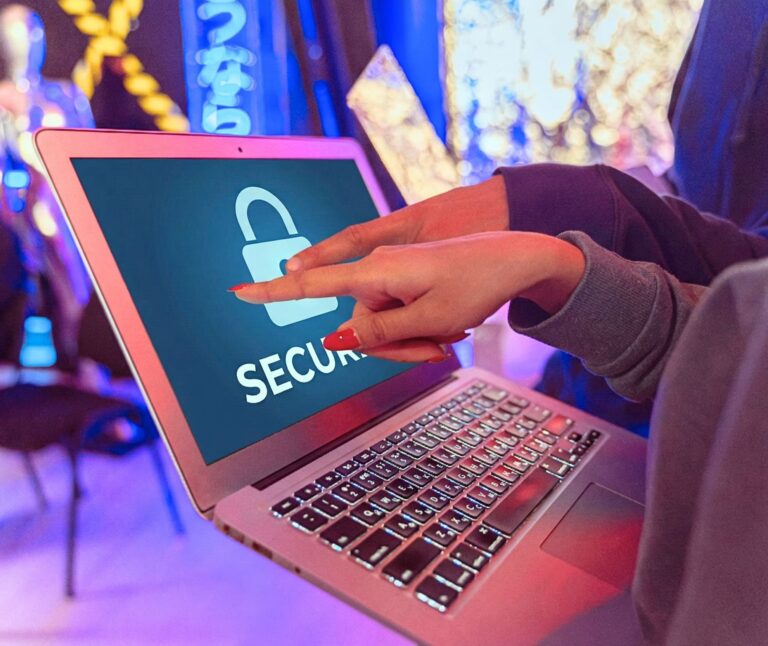 Two hands point at a laptop screen displaying a padlock icon and the word “SECURE” in bold, symbolizing Scale via Cybersecurity Investment Opportunities through digital protection, enterprise-grade security tools, and strategic investment in cyber infrastructure that enables scalable growth, trust, and resilience in the tech-driven economy.