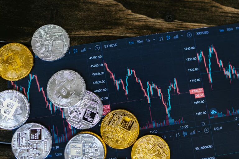 Physical cryptocurrency coins rest atop a digital trading chart displaying ETH/USD and XRP/USD candlestick patterns, symbolizing The On-Chain Evolution Cryptocurrency and Digital Transformation through the convergence of tangible crypto assets and real-time market data, highlighting blockchain adoption, decentralized finance, and the dynamic nature of digital asset ecosystems.