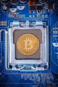 A golden Bitcoin coin rests in the center of a computer motherboard’s CPU socket, surrounded by capacitors, resistors, and circuits on a blue PCB, symbolizing Future of Fintech Innovation Investment through blockchain-powered infrastructure, founder-led digital finance strategies, and technology-driven capital growth that empower businesses to merge hardware innovation with decentralized currency, scale fintech ecosystems, and unlock new pathways for sustainable investment.